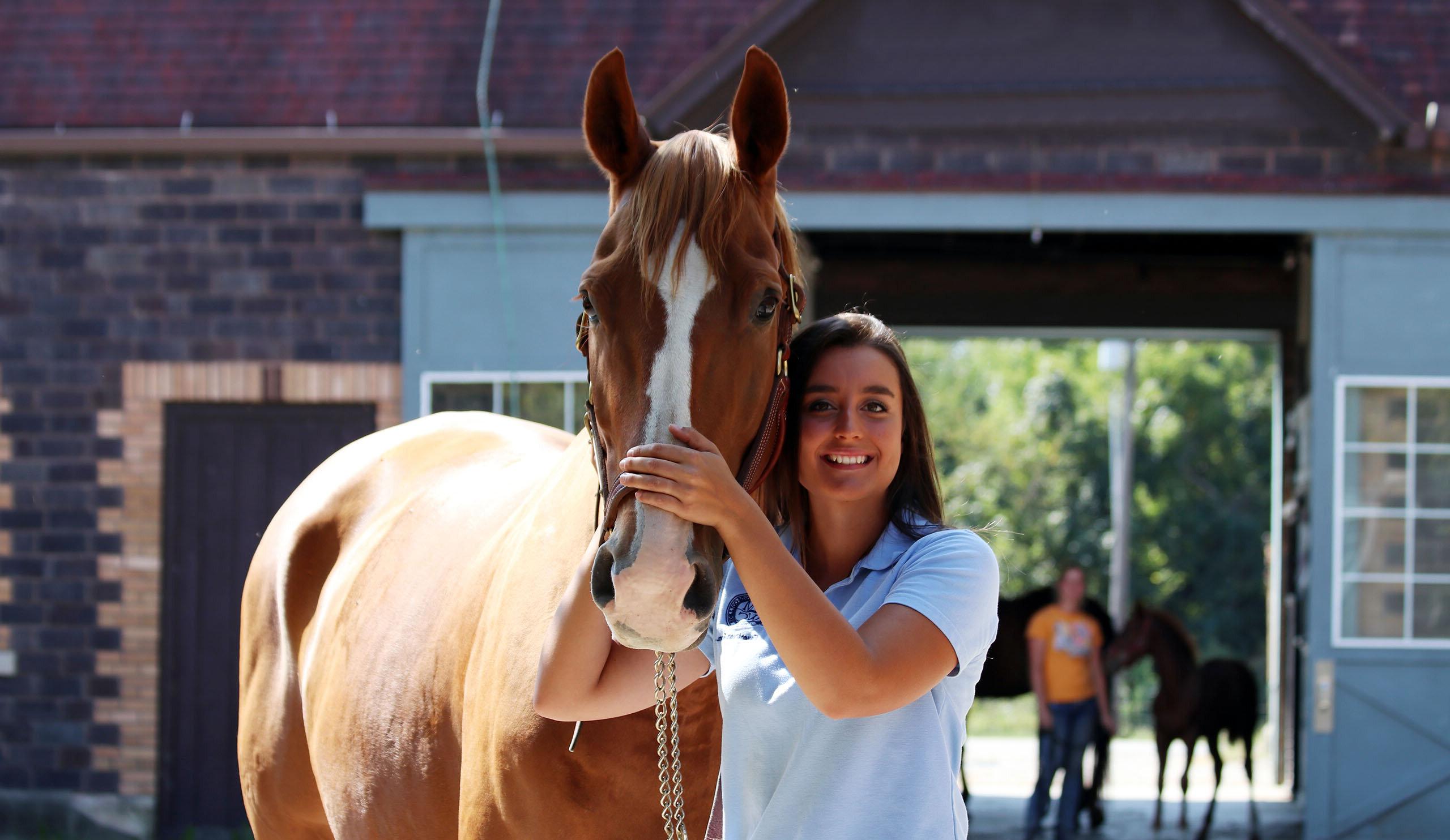 Savannah smiling with a horse